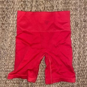 Aritzia TNA biker shorts. Color red/orange, size small